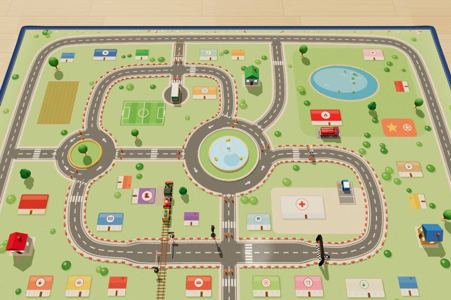 A play-mat town with roads, houses and a roundabout, seen from above